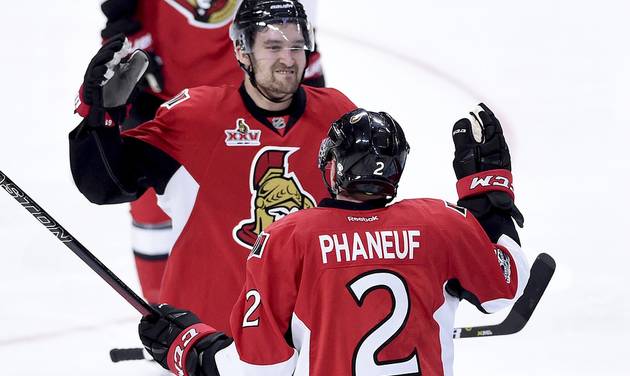 Ottawa Senators defenseman Dion Phaneuf is congratulated by teammate Ottawa Senators right wing Mark Stone on his goal during overtime of game two NHL Stanley Cup hockey playoff action against the Boston Bruins in Ottawa Saturday