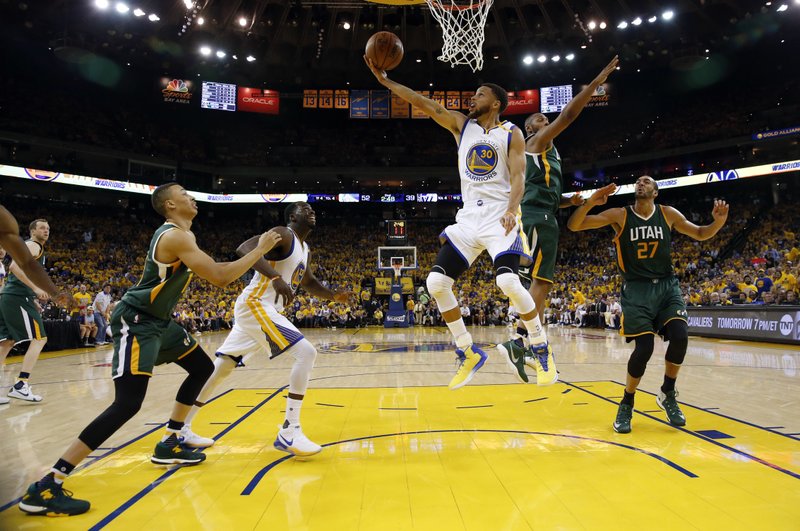 Golden State Warriors&#039 Stephen Curry scores against the Utah Jazz during the first half in Game 1 of an NBA basketball second-round playoff series Tuesday