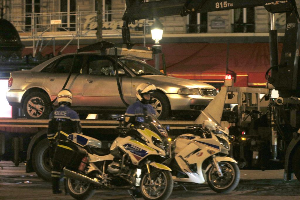 The car belonging to an attacker is towed away from the Champs Elysees avenue in Paris France after a fatal shooting in which a police officer was killed along with the attacker Friday