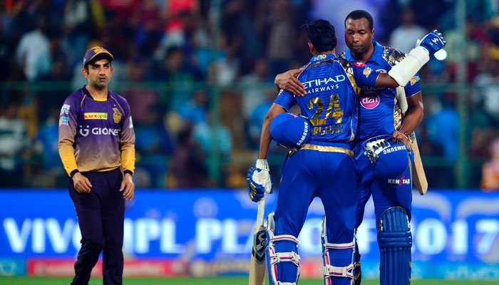 Kolkata Knight Riders captain Gautam Gambhir looks on as Mumbai Indians batsmen Keiron Pollard and Krunal Pandya celebrate their win