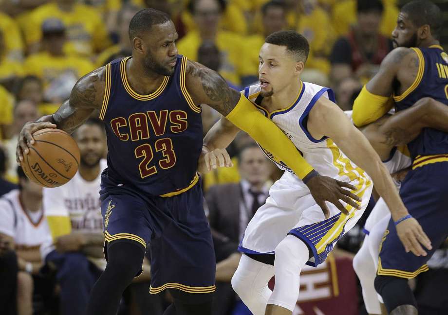 Cleveland Cavaliers forward Le Bron James dribbles against Golden State Warriors guard Stephen Curry during the first half of Game 1 of basketball's NBA Finals in Oakland Calif. While there have been 14 rematc