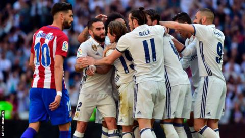 Real Madrid's players celebrate scoring against Atletico Madrid