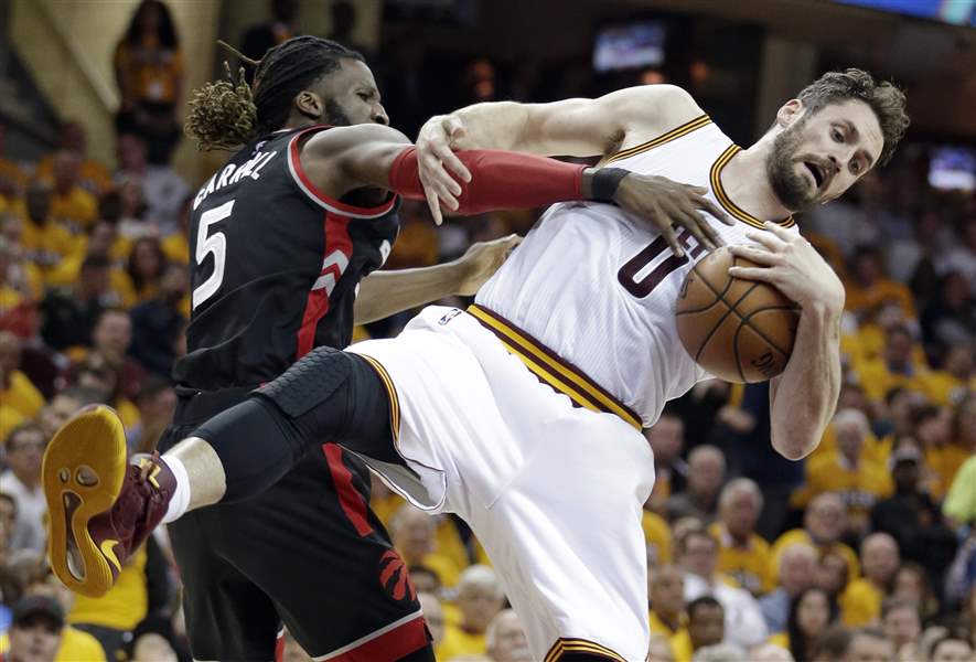 Toronto's De Marre Carroll left puts pressure on Cleveland's Kevin Love in the first half Monday. AP   
    AP