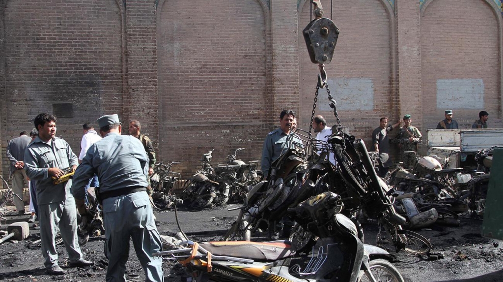 Afghan policemen inspects at the site of a blast in Herat Afghanistan