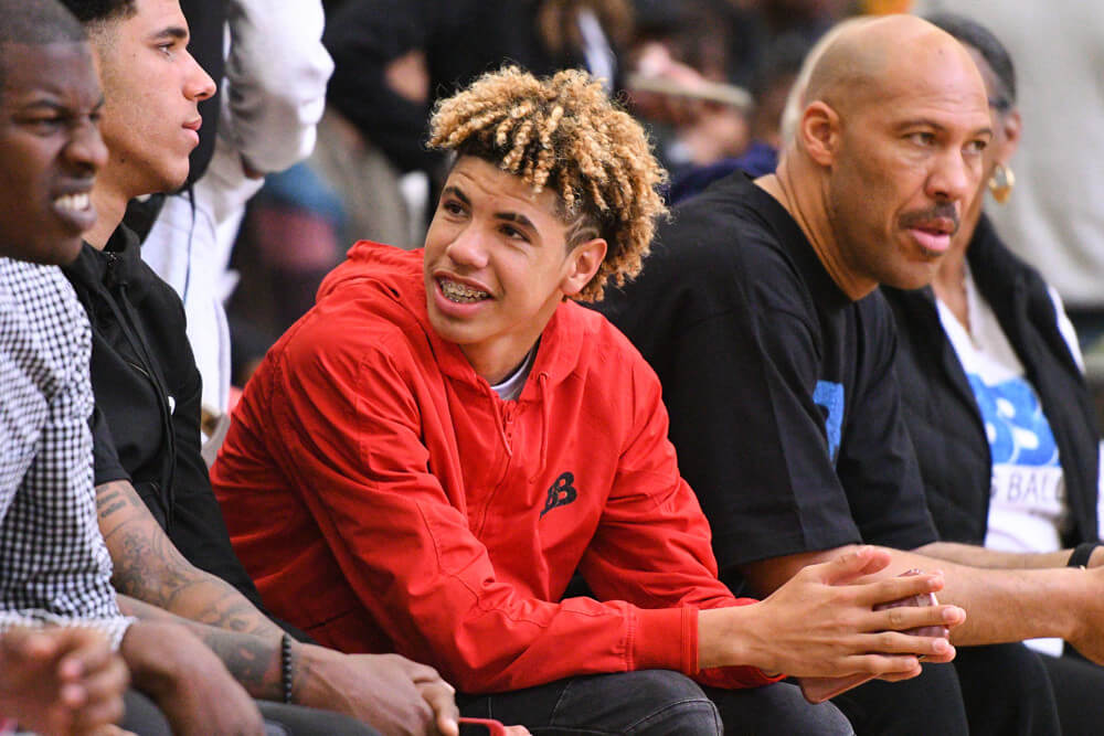 LONG BEACH CA- MAY 06 La Melo Ball headed to UCLA looks on with his brother Lonzo and dad Lavar during the 2017 Ballislife All American game