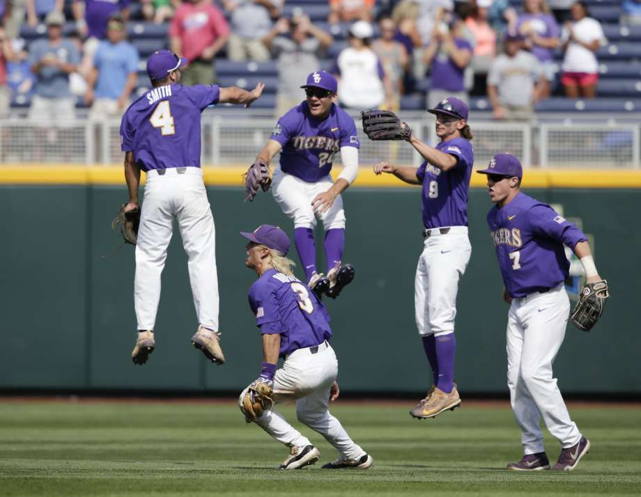 LSU players jump for joy in the outfield after beating Oregon State