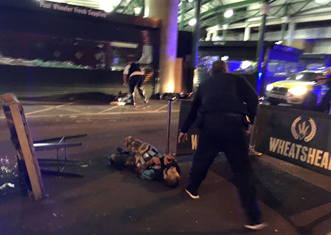 Members of the Police and Ambulance service assess the scene on London Bridge following the terror attack. — AFP