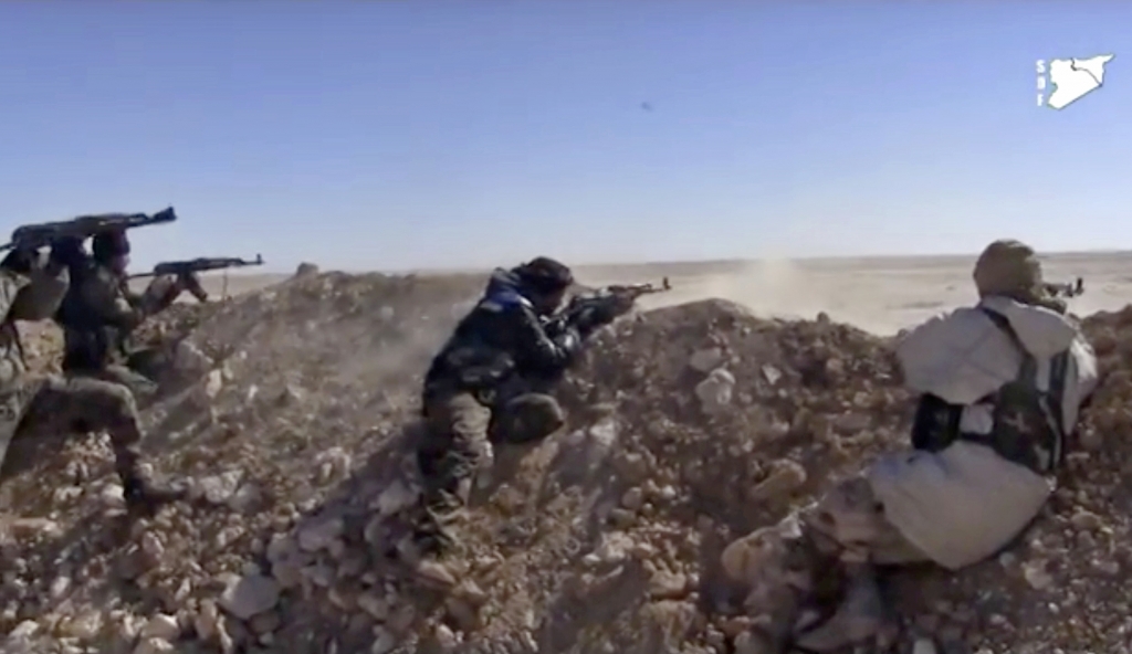 Syrian Democratic Forces fighters opening fire on an Islamic State group's position in March in the countryside east of Raqqa Syria