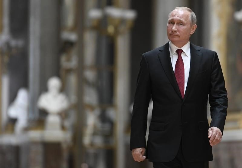 Putin walks in the Galerie des Batailles as he arrives for a joint press conference with French President Emmanuel Macron following their meeting at the Versailles Palace near Par