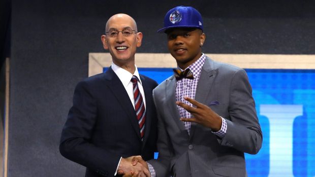 Markelle Fultz walks on stage with NBA commissioner Adam Silver after being drafted first overall by the Philadelphia 76ers