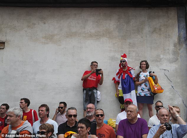 Spectators watch the riders arrive for the start of the thirteenth stage of the Tour de France cycling race over 101 kilometers with start in Saint Girons and finish in Foix France Sunday