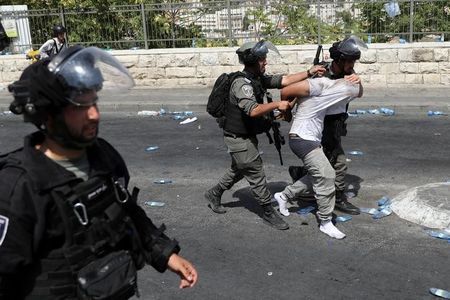 Israeli security forces arrest a Palestinian man following clashes outside Jerusalem's Old city