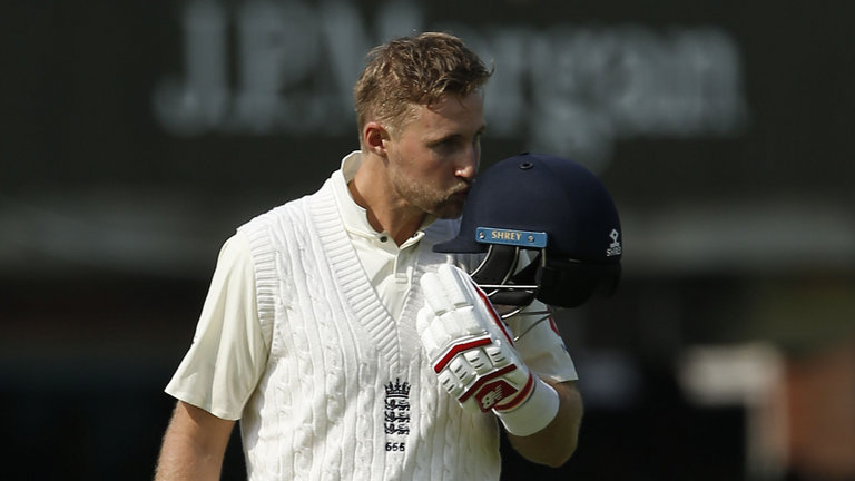 Joe Root kisses the England badge as he scores a century in his first Test as captain