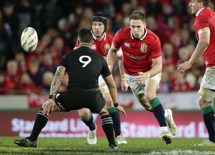 Lions fullback Liam Williams right eyes ball as New Zealand halfback Aaron Smith left prepares to tackle during the third and final rugby test between the British and Irish Lions and the All Blacks at Eden Park in Auckland New Zealand Saturday July