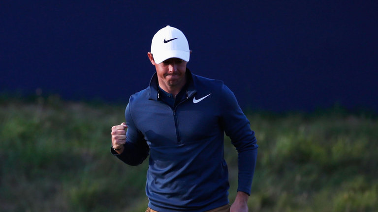 McIlroy celebrates after ending his round with a birdie at the 18th