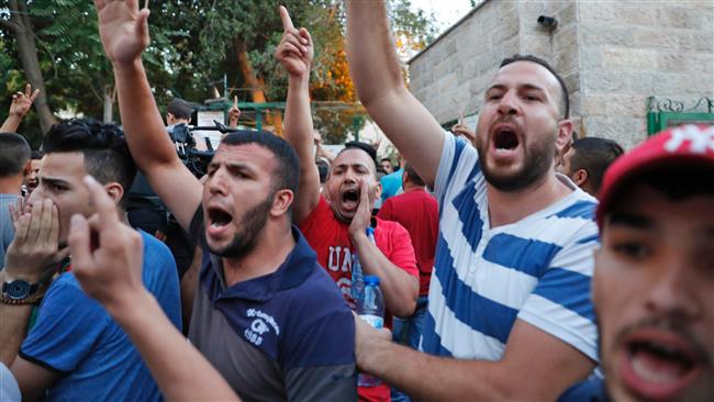 Palestinian protestors shout slogans during a demonstration in Jerusalem al Quds