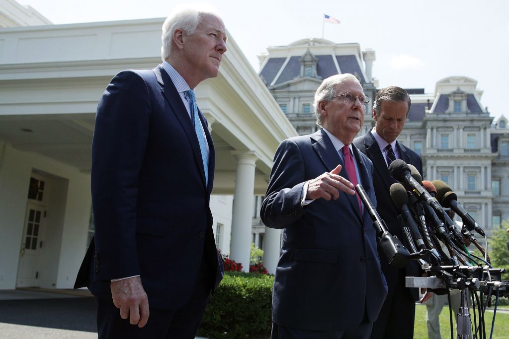 Senate Majority Leader Sen. Mitch Mc Connell speaks to members of the media as Sen. John Cornyn left and Sen. John Thune look on outside the West Wing of the White House after a lunch meeting with President Donald Trump to talk about health care on Wedne