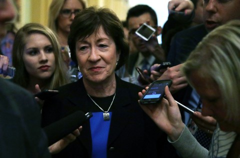 Sen. Susan Collins is surrounded by reporters Thursday on Capitol Hill