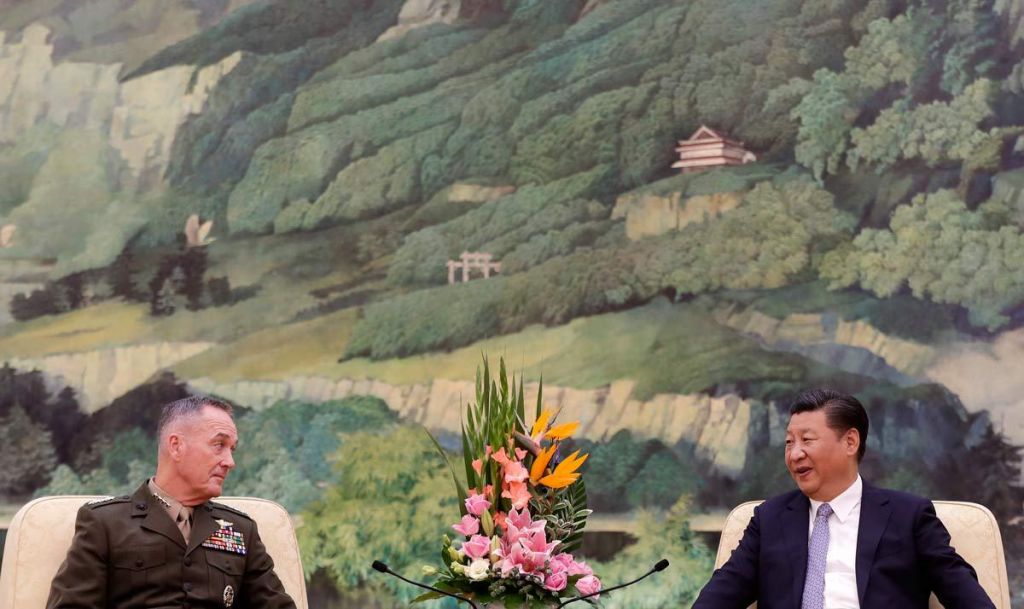 U.S. Chairman of the Joint Chiefs of Staff Gen. Joseph Dunford left chats with President Xi Jinping during a meeting at the Great Hall of the People in Beijing Thursday Aug. 17 2017