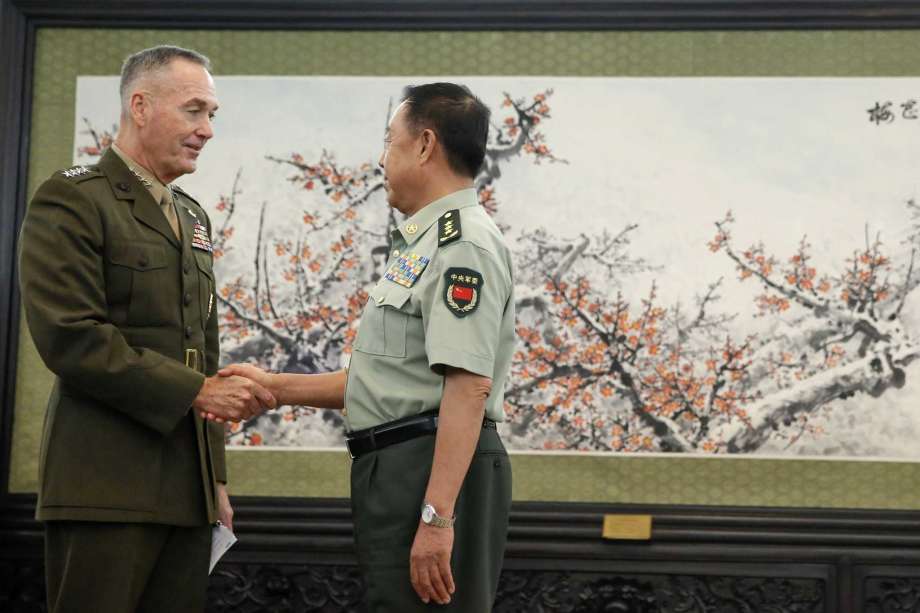 U.S. Chairman of the Joint Chiefs of Staff Marine Corps Gen. Joseph Dunford left shakes hands with China's Central Military Commission Vice Chairman Fan Changlong at the Bayi Building in Beijing China Thursday Aug. 17 2017. (Thomas Peter  Pool Phot