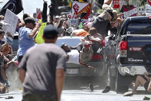 People fly into the air as a vehicle drives into a group of protesters demonstrating against a white nationalist rally in Charlottesville Va. on Aug. 12 2017. Ryan M. Kelly  The Daily Progress via AP