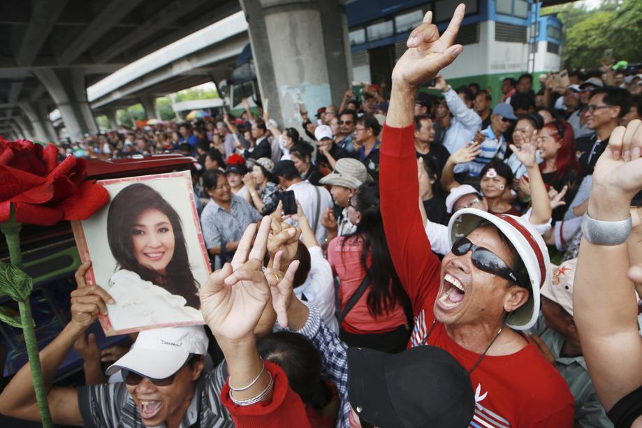 Supporters of Thailand's former Prime Minister Yingluck Shinawatra dance outside the Supreme Court after Yingluck failed to show up to hear a verdict in Bangkok Thailand Friday Aug. 25 2017. Thailand's Supreme Court said Friday it will issue an arrest