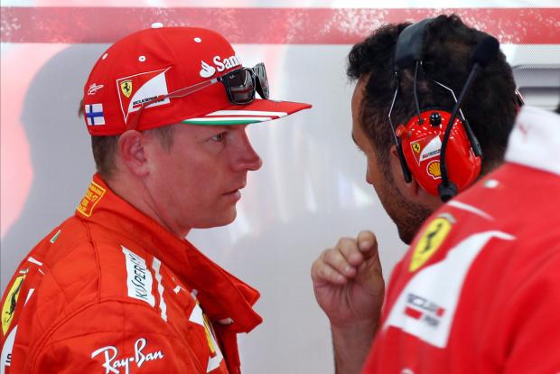 Kimi Raikkonen talk with his mechanic after the opening session of the Belgian GP