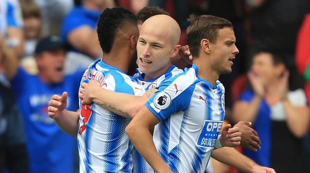 Huddersfield's Australian midfielder Aaron Mooy celebrates with teammates after scoring against Newcastle on Sunday