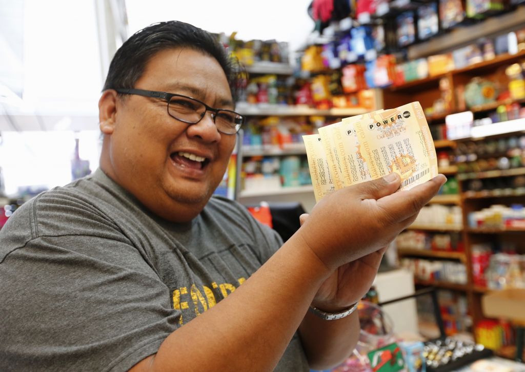 Claudio Salamanca of Santa Clara holds up the $120 worth of Powerball lottery tickets he purchased at Hana's Bottle Shop Liquors in Santa Clara California on Wednesday