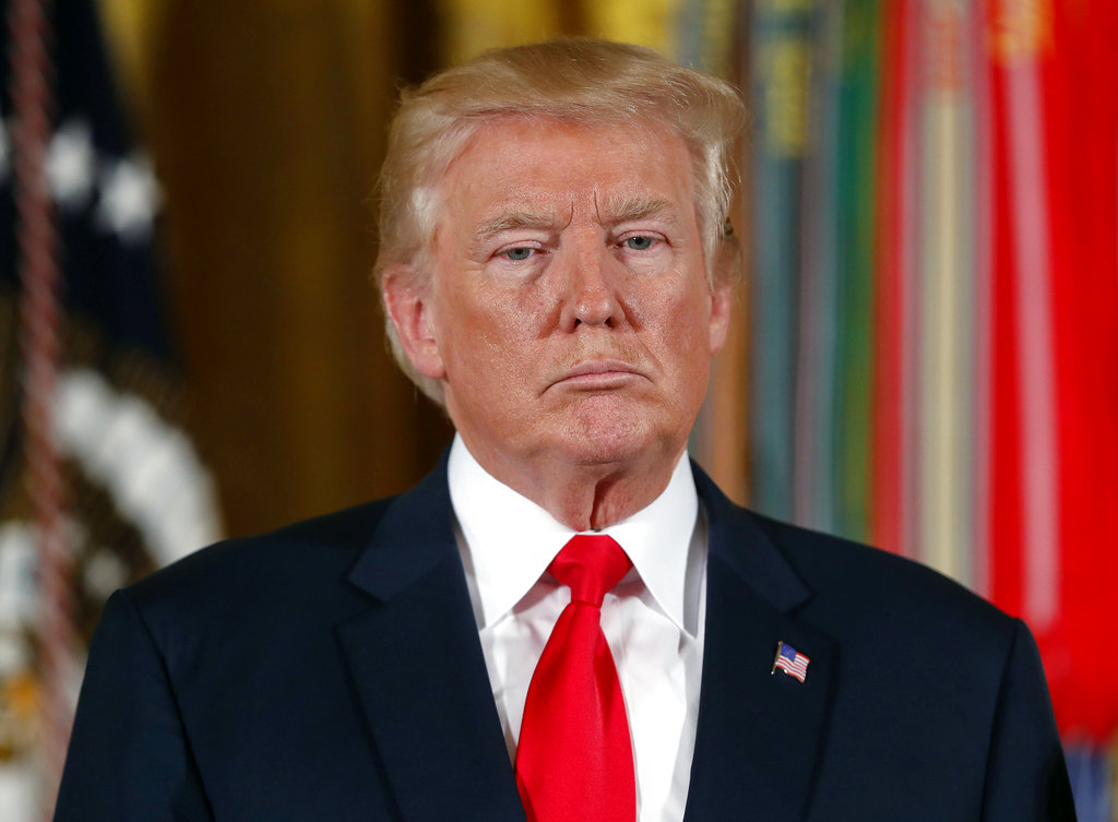 President Donald Trump pauses during a ceremony in the East Room of the White House