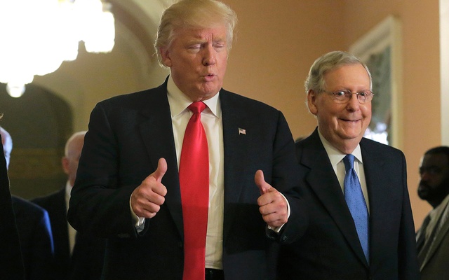 Trump gives a thumbs up sign as he walks with Senate Majority Leader Mitch Mc Connell on Capitol Hill in Washington US