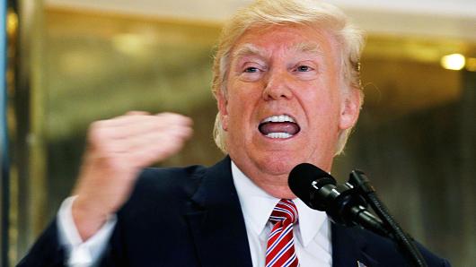 President Donald Trump answers questions about his responses to the violence injuries and deaths at the'Unite the Right rally in Charlottesville as he talks to the media in the lobby of Trump Tower in Manhattan New York