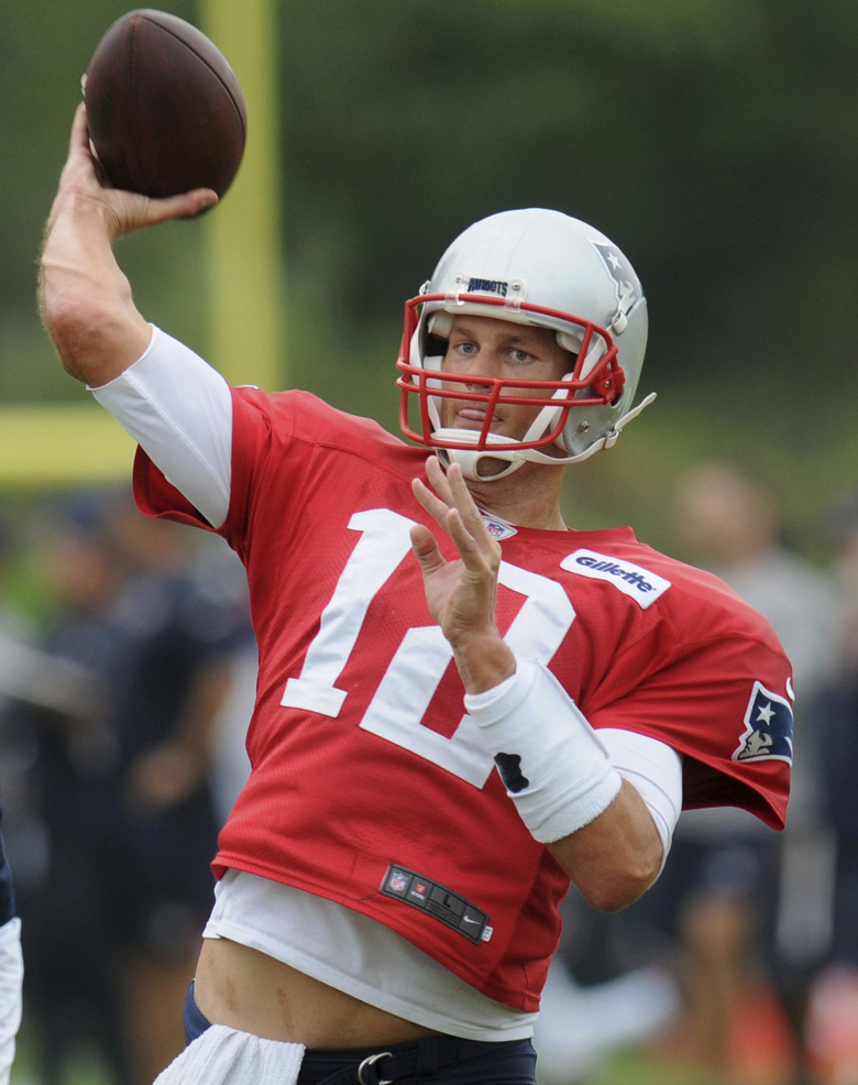 New England Patriots quarterback Tom Brady works on passing drills during a joint practice with the NFL football team Houston Texans in White Sulphur Springs