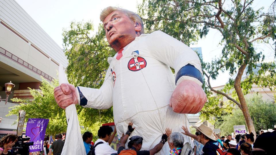 Pro-Trump supporters face off with peace activists during protests outside a Donald Trump campaign rally in Phoenix Arizona