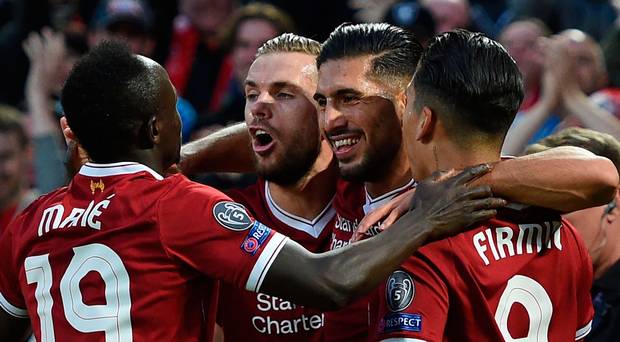 Liverpool's German midfielder Emre Can celebrates with teammates scoring his team's first goal during the Champions League qualifier second leg match between Liverpool and Hoffenheim at Anfield stadium in Liverpool