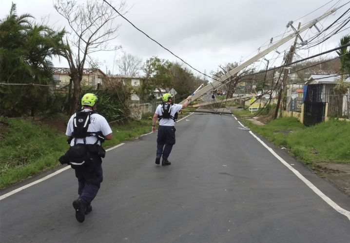 Crew members assess electrical lines in the aftermath of Hurricane Maria on Friday in Puerto Rico. Mobile communications systems are being flown in but “it’s going to take a while.&#8221