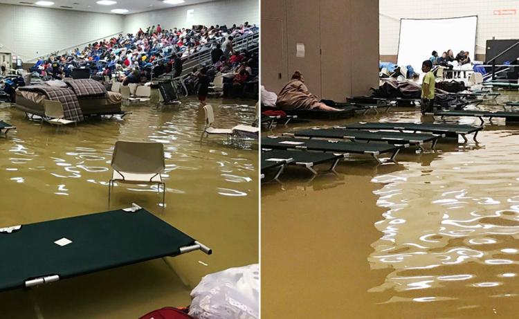 Evacuees sit in the bleachers at the Bowers Civic Center in Port Arthur Texas as it floods on Wednesday