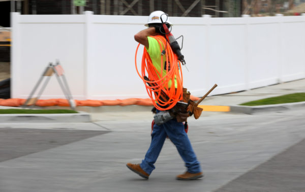 MIKE BLAKE | REUTERS | BDN
  MIKE BLAKE | REUTERS | BDN  A construction workers carries his gear to a job site in Carlsbad California