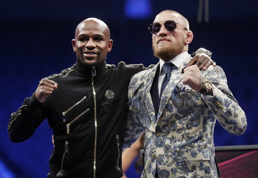 Floyd Mayweather Jr. left and Conor Mc Gregor pose during a news conference after a super welterweight boxing match Sunday Aug. 27 2017 in Las Vegas