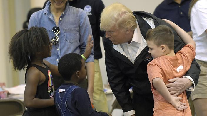 President Donald Trump and Melania Trump meet people impacted by Hurricane Harvey during a visit to the NRG Center in Houston