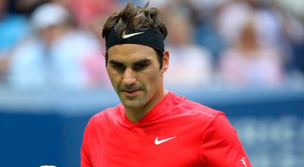 Relieved Roger Federer celebrates a winning point on his way to a five-set victory over Mikhail Youzhny at the US Open