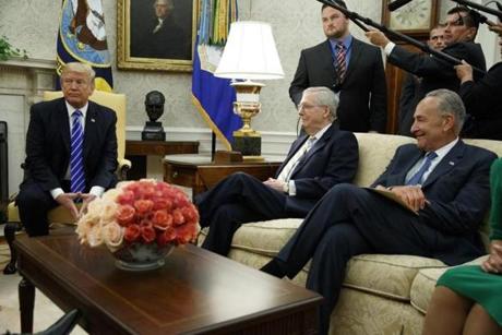 Senate Majority Leader Mitch McConnell R-Ky. center and Senate Minority Leader Chuck Schumer D-N.Y. right are shown with President Donald Trump during a meeting with other Congressional leaders in the Oval Office of the White House Wednesday Sept