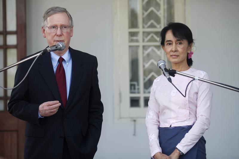 US Senator Mitch McConnell left talks to reporters after meeting Aung San Suu Kyi at her home in Rangoon on 16 January 2012