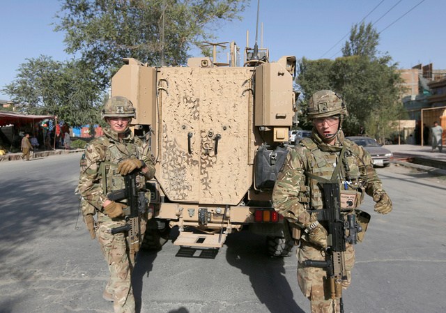 NATO soldiers arrive at the site of a suicide attack followed by a clash between Afghan forces and insurgents after an attack on a Shi'ite Muslim mosque in Kabul Afghanistan