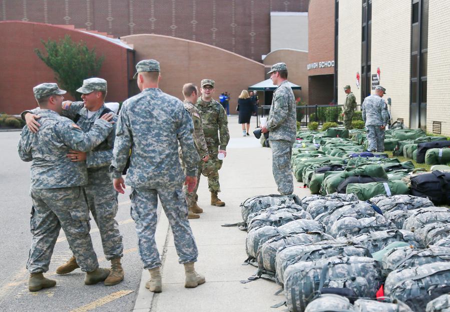 Sgt. Ryan Webb of Morrow center says goodbye to fellow soldiers Colton Palmer and Daniel Kloppenburg after returning from deployment Thursday Aug. 4 2016. More than 100 members of the Middletown-based Ohio Army National Guard's 324th Military Police