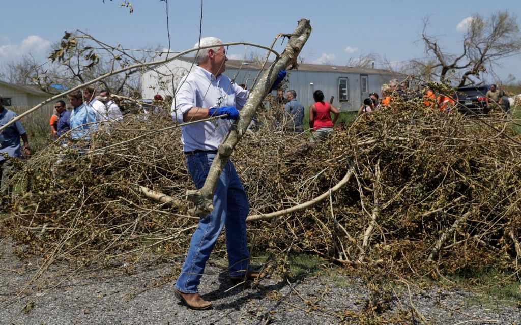 Vice President Mike Pence helps move debris during a visit to an area hit by Hurricane Harvey Thursday Aug. 31 2017 in Rockport Texas Credit AP