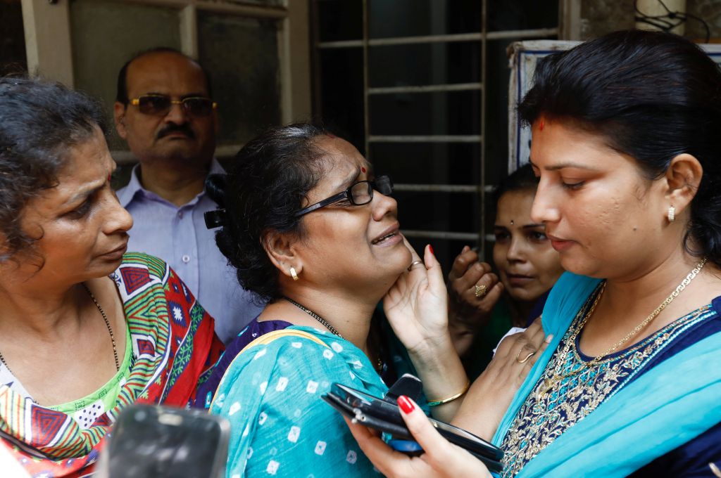 A relative of a stampede victim grieves at a hospital in Mumbai