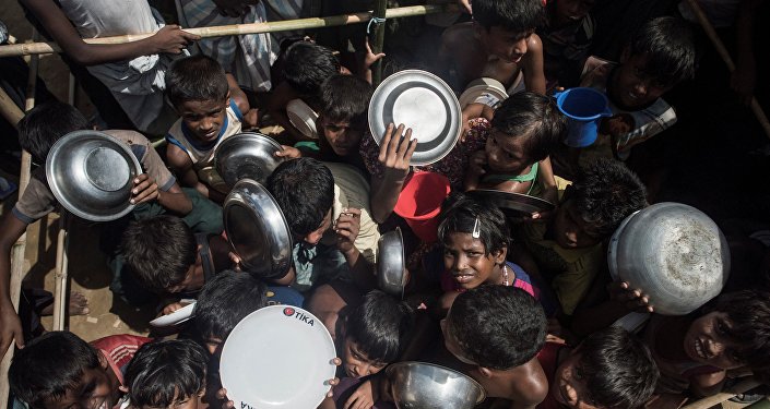 Rohingya Muslim refugees children rush to line up at a food distribution in Balukhali refugee camp near Gumdhum on September