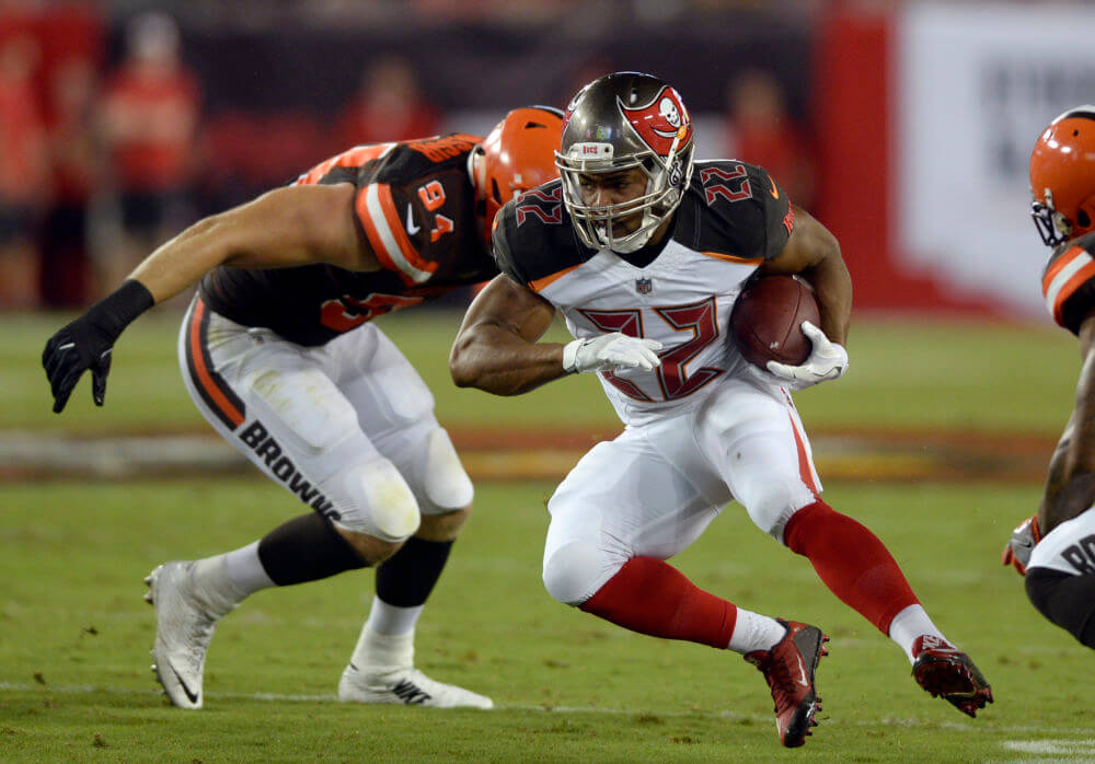 Tampa Bay Buccaneers running back Doug Martin eludes Cleveland Browns defensive end Carl Nassib during the second quarter of an NFL preseason football game Saturday Aug. 26 2017 in Tampa Fla