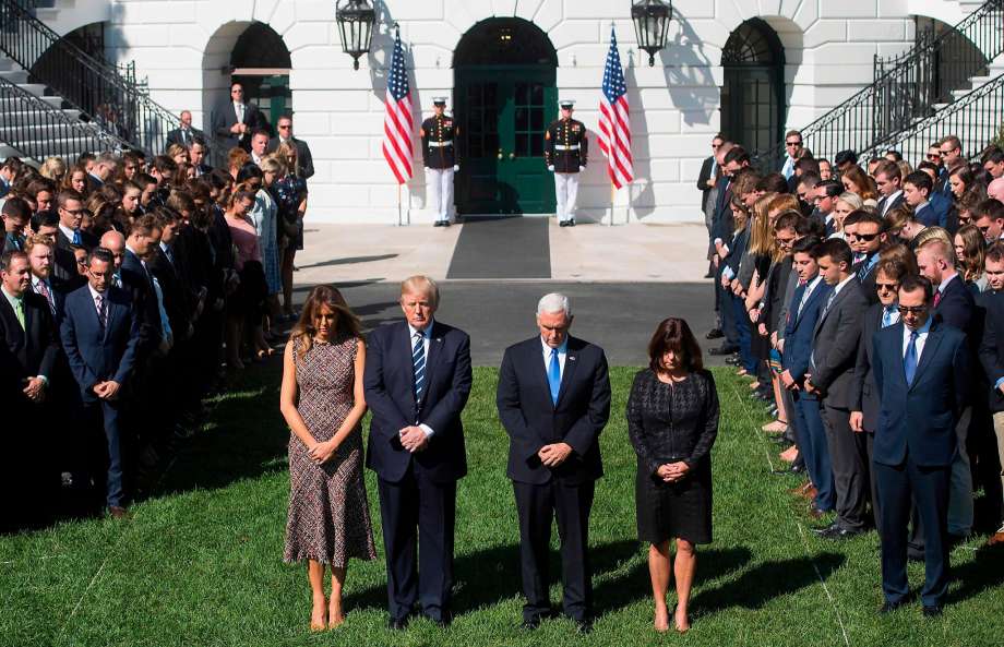 US President Donald Trump First Lady Melania Trump US Vice President Mike Pence and his wife Karen participate in a moment of silence on the South Lawn of the White House in Washington DC